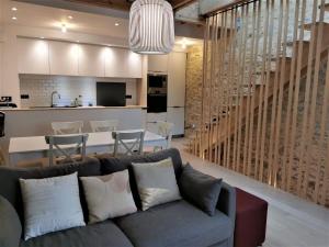 a living room and kitchen with a couch and a table at Ancienne sous-prefecture in Les Sables-dʼOlonne