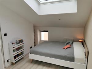 a white bedroom with a bed and a window at Ancienne sous-prefecture in Les Sables-dʼOlonne