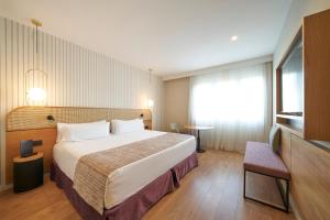 a hotel room with a bed and a television at Catalonia Diagonal Centro in Barcelona