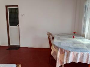 a room with a table and chairs and a window at Tropical Point Inn in Matara