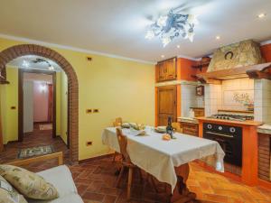 a kitchen with a table with a white table cloth at Apartment Lara by Interhome in Marina di Massa