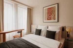 a hotel room with a bed and a window at Warszauer Hotel in Krakow