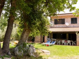 Villa Il Casolare by Interhome في سبرلونغا: منزل به ساحة مع كراسي وطاولة