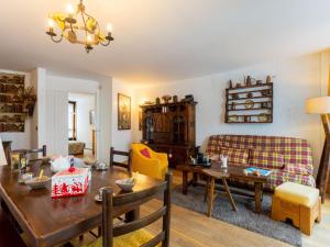 a living room with a table and a couch at Apartment Le Beau Site by Interhome in Chamonix-Mont-Blanc