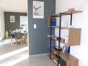 a living room with a book shelf with books at Holiday Home Villa Lanka by Interhome in Arzon