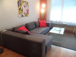a living room with a couch and a table at Apartment Sunnmatt West Wohnung 744 by Interhome in Engelberg