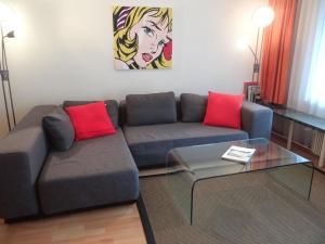 a living room with a couch and a glass table at Apartment Sunnmatt West Wohnung 744 by Interhome in Engelberg