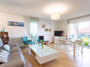 a living room with a couch and a table at Apartment IBIRY by Interhome in Ciboure