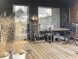 a patio with a table and chairs on a deck at Holiday Home Kasnäs marina a 7 by Interhome in Kasnäs