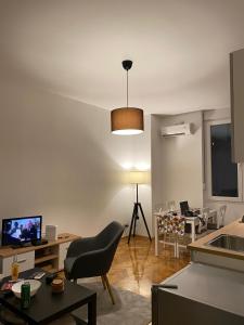 a living room with a chair and a table with a computer at Apartment Major in Belgrade