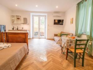 a living room with a table and a couch at Apartment Alighieri by Interhome in Bolsena