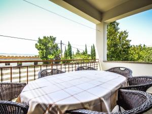 a porch with a table and chairs on a balcony at Holiday Home Marija by Interhome in Rovanjska +16 photos