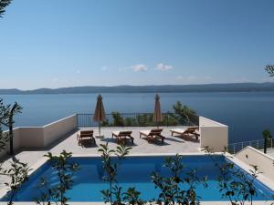 a swimming pool with a view of a body of water at Holiday Home Lada - OMI205 by Interhome in Marusici 