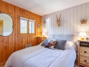 a bedroom with a large white bed and a mirror at Apartment les Huskies by Interhome in Saint-Gervais-les-Bains