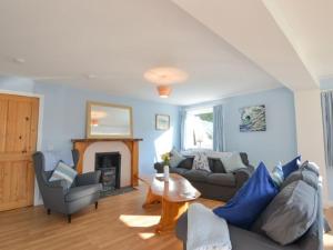 a living room with a couch and a fireplace at Holiday Home Tigh na Sith by Interhome in Oban