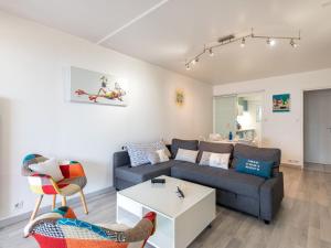 a living room with a couch and a table at Apartment Ker Eol by Interhome in Carnac