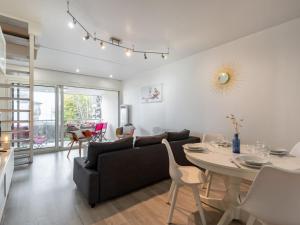 a living room with a couch and a table at Apartment Ker Eol by Interhome in Carnac