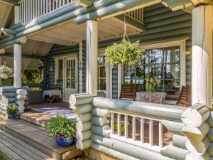 a front porch of a house with a wooden deck at Holiday Home Honkaniemi by Interhome in Hiukkajoki