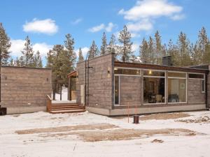 a home in the woods with a large building at Holiday Home Solokoto by Interhome in Inari