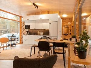 a kitchen and dining room with a table and chairs at Holiday Home Solokoto by Interhome in Inari