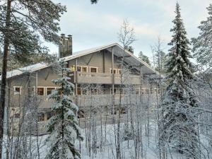 a house in the woods in the snow at Holiday Home Puolikuu a7 by Interhome in Sirkka