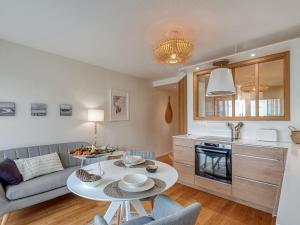 a living room with a couch and a table at Studio La Cormorane-6 by Interhome in Carnac