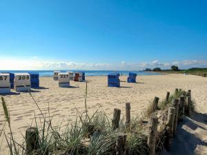 a beach with blue beach bins in the sand at Apartment Anke by Interhome in Damp