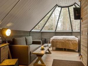 a room with a couch and a bed in a attic at Holiday Home Samruam 1 b by Interhome in Salla