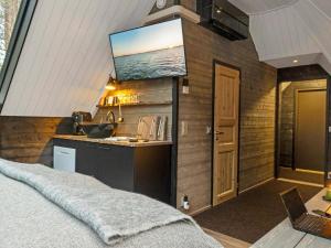 ein Schlafzimmer mit einem Waschbecken und einem TV an der Wand in der Unterkunft Holiday Home Samruam b aurora cabin by Interhome in Salla