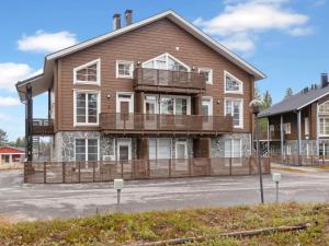 a large wooden house with a balcony on a street at Holiday Home Levin alppi a3 by Interhome in Sirkka