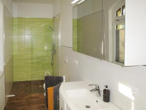 a white bathroom with a sink and a shower at Apartment Rose by Interhome in Zarrentin