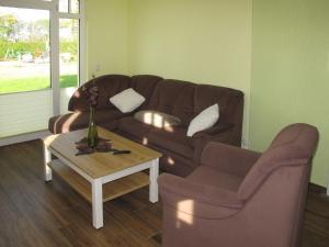 a living room with a couch and a coffee table at Apartment Rose by Interhome in Zarrentin +23 photos