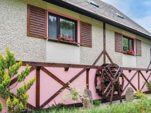 ein Haus mit einem rosa Zaun und Fenstern in der Unterkunft Holiday Home Chlívce u Hronova-5 by Interhome in Chlívce