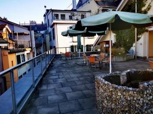 un patio con sombrilla, mesas y sillas en Apartment B&B am Berntor by Interhome en Thun
