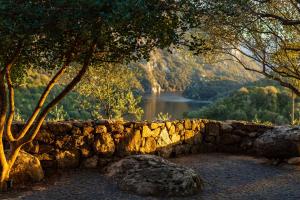 a stone wall with a view of a lake at Agriturismo Canales in Dorgali