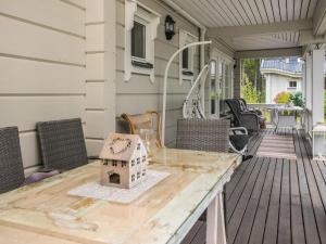 a table on a porch with a bird house on it at Holiday Home Tyssinniemi by Interhome in Hiukkajoki