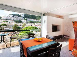 a dining room with a table and a large window at Apartment Naranja by Interhome in Tossa de Mar
