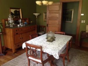 a dining room with a table and chairs and a dresser at Delano Bed and Breakfast in Wichita