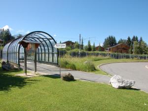 a sign in the grass next to a road at Apartment Grenat 8 by Interhome in Villars-sur-Ollon