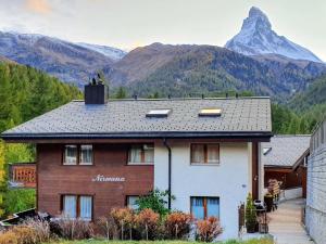 ein Haus mit einem Berg im Hintergrund in der Unterkunft Apartment Nirwana by Interhome in Zermatt