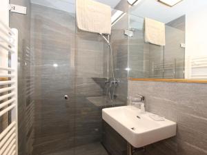 a bathroom with a sink and a glass shower at Holiday Home Zeller by Interhome in Stummerberg