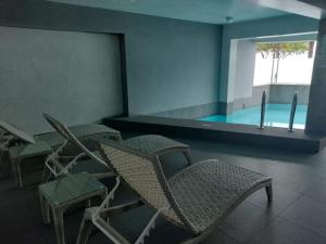 a group of chairs in a room with a swimming pool at Outstanding Ocean View 2BR 2BA Pool Gym by GLOBALSTAY in Lima