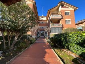 a sidewalk in front of a building with trees at Attico a Roma in Rome