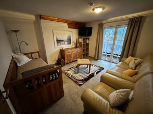 a living room with a couch and a bed and a tv at Fanky Guided Sport & Outdoor Experience - Hostel & Appartementhaus - Rafting&Canyoning in Haiming