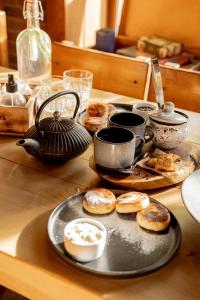 a table with a tray of donuts on a table at Guest House Old Boys in Krasnaya Polyana