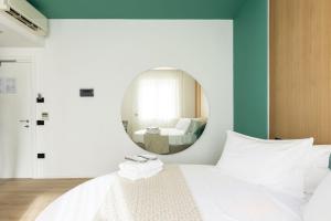 a bedroom with a mirror and a bed at Plana Hotel in Caserta