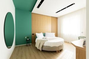 a bedroom with a bed and a large window at Plana Hotel in Caserta