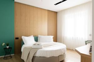 Ένα ή περισσότερα κρεβάτια σε δωμάτιο στο Plana Hotel