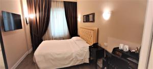 Postel nebo postele na pokoji v ubytování Hotel Patavium