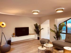 a living room with a flat screen tv on a wall at Ferienhaus Kutscherhäuschen in Eisenach